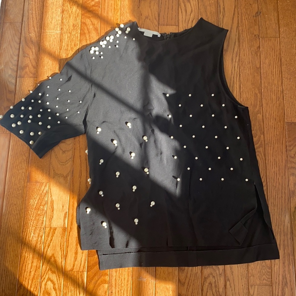 Stella McCarthy black with pearls one shoulder shirt